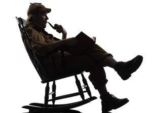 Sherlock Holmes reading a book in a rocking chair